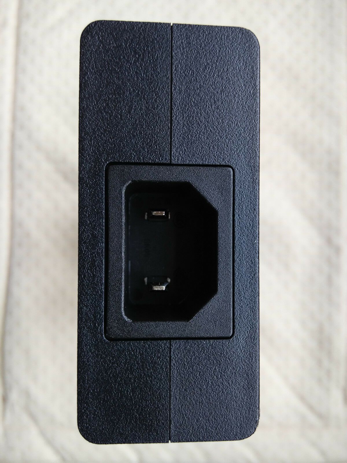 Close-up of input port on Sony ACDP-240E01 adapter for 100-240V AC input.